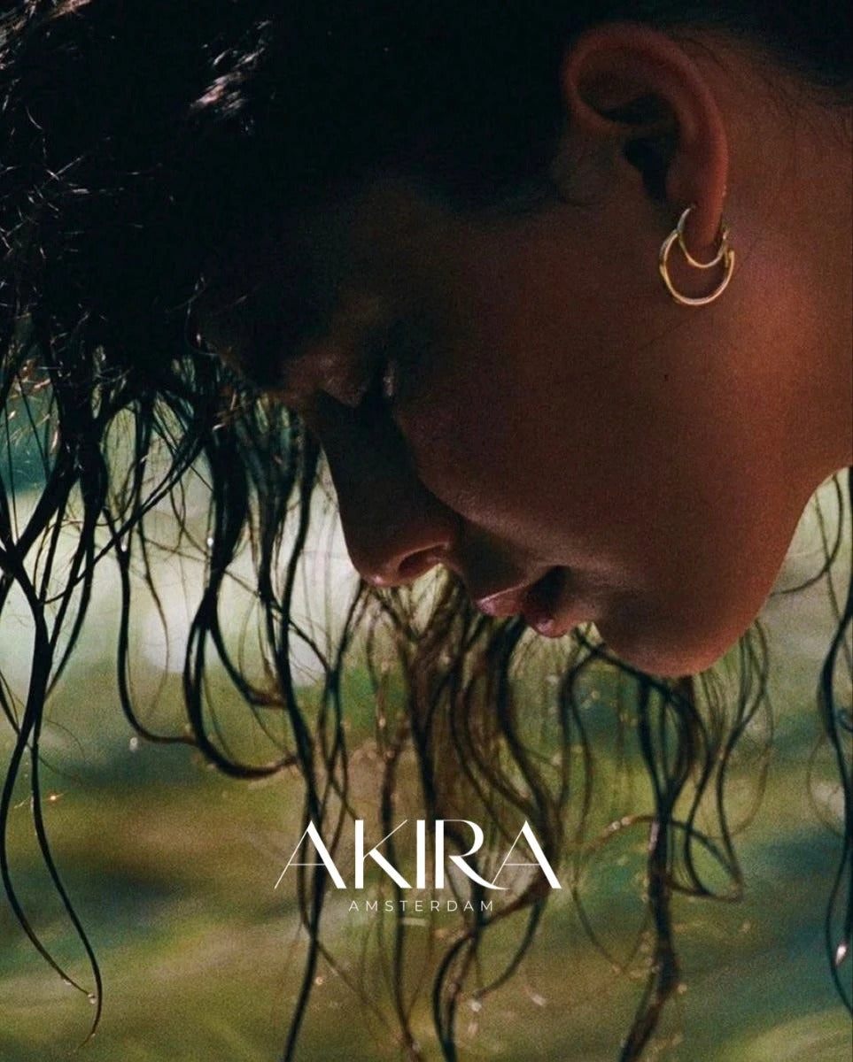 Akira Amsterdam: woman with wet hair wearing gold hoop earrings